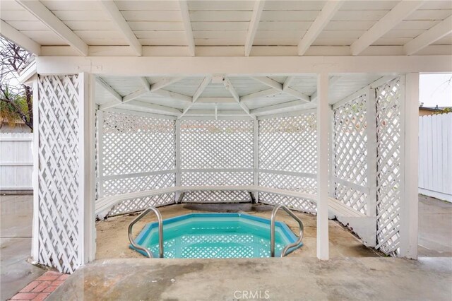 view of swimming pool with a hot tub and a gazebo