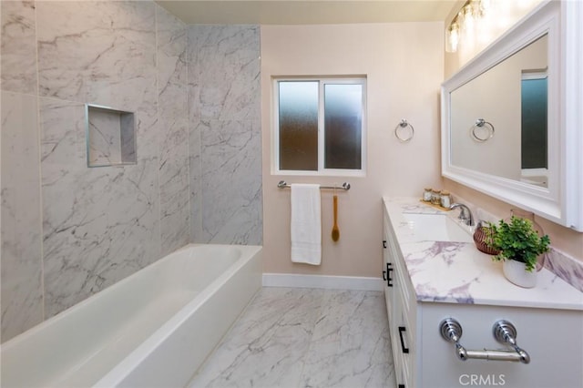 bathroom with tiled shower / bath combo and vanity