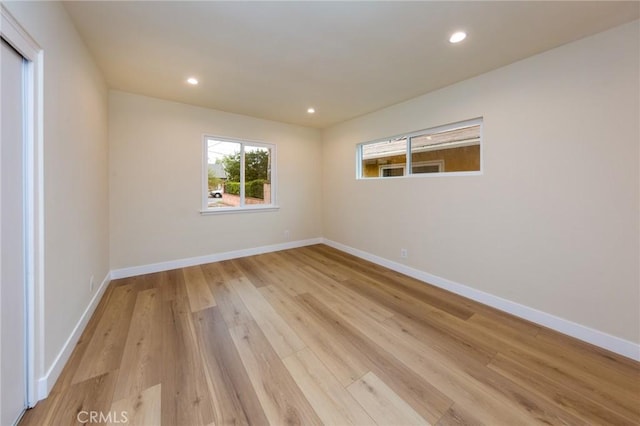 spare room featuring light hardwood / wood-style flooring