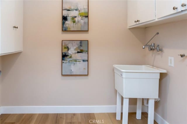 laundry room with light hardwood / wood-style flooring