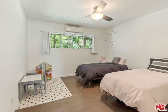 bedroom with ceiling fan, hardwood / wood-style flooring, and a wall mounted AC