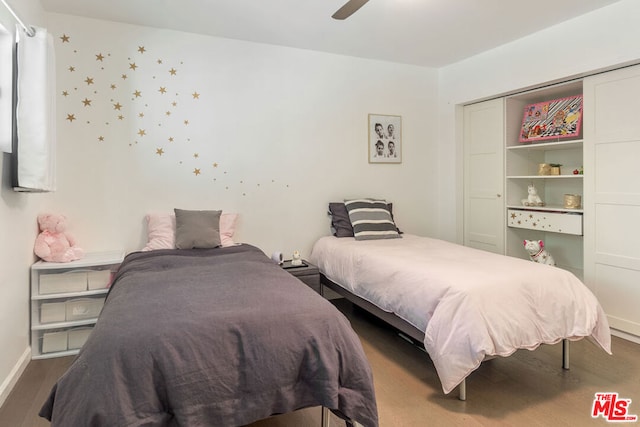 bedroom with ceiling fan, dark hardwood / wood-style flooring, and a closet