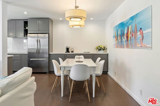 dining space with dark hardwood / wood-style flooring