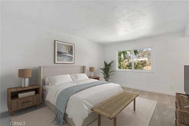 bedroom with light colored carpet