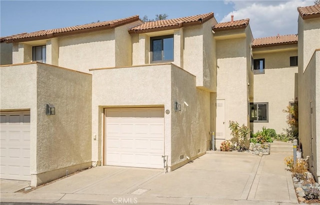 mediterranean / spanish home featuring a garage