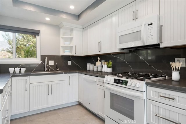 kitchen with white cabinetry, sink, white appliances, and backsplash