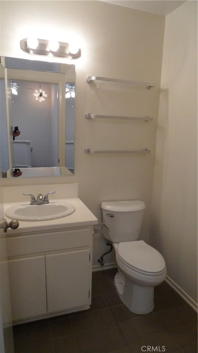 bathroom with vanity, tile patterned flooring, and toilet