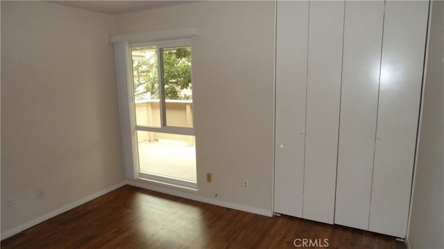 unfurnished bedroom featuring dark wood-type flooring