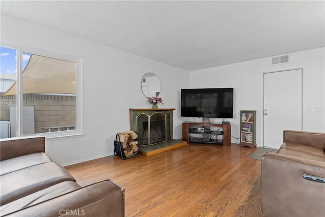 living room featuring hardwood / wood-style flooring and a textured ceiling