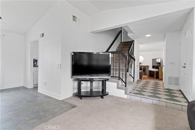 entrance foyer with vaulted ceiling and carpet