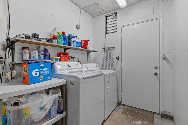 clothes washing area with washer and clothes dryer