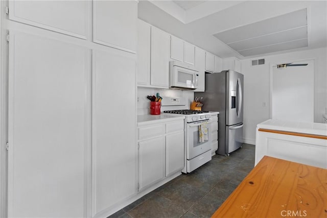 kitchen featuring white cabinetry and white appliances