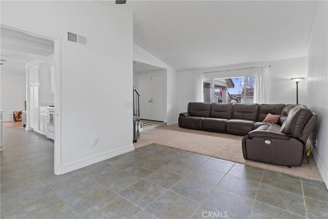 carpeted living room with vaulted ceiling