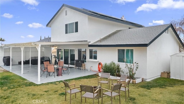 back of property with a patio, a pergola, and a lawn