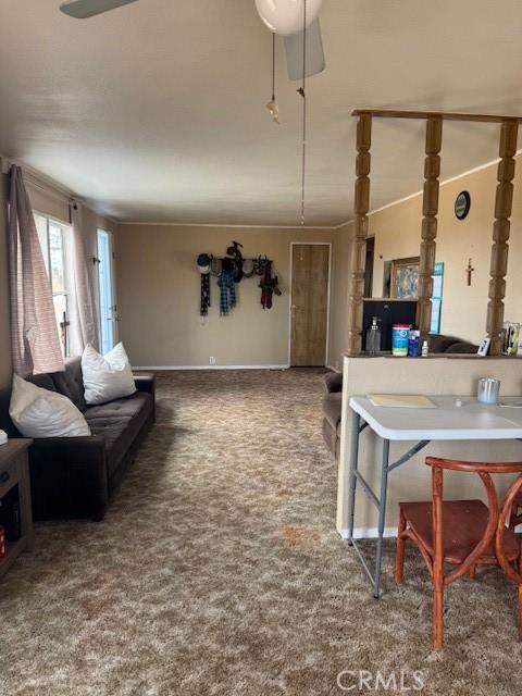 carpeted living room with ceiling fan