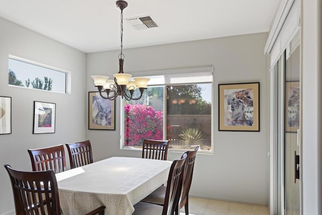 dining area featuring an inviting chandelier