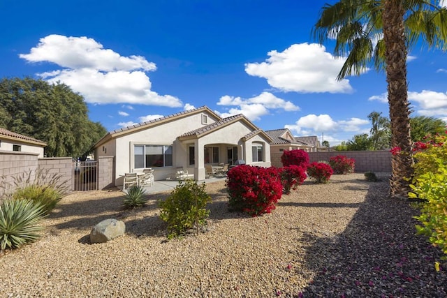 back of property with a patio