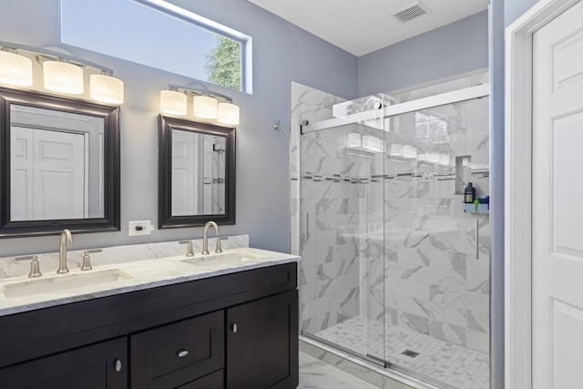 bathroom with vanity and a shower with shower door