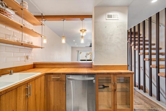 bar with pendant lighting, butcher block countertops, sink, stainless steel dishwasher, and ceiling fan