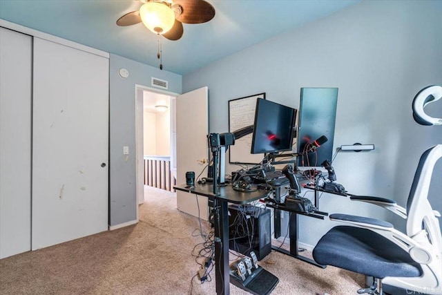 carpeted home office with ceiling fan