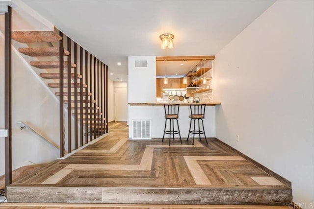 interior space with parquet floors and backsplash