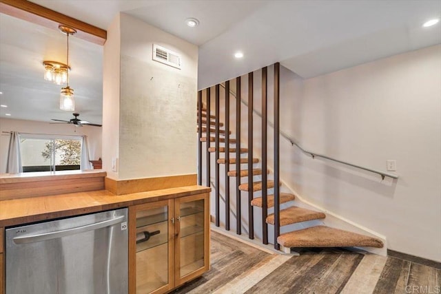 bar with hardwood / wood-style flooring, butcher block counters, dishwasher, and hanging light fixtures