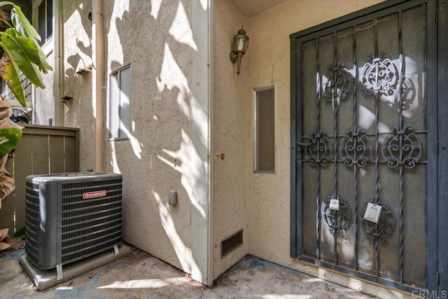 view of exterior entry featuring central AC unit