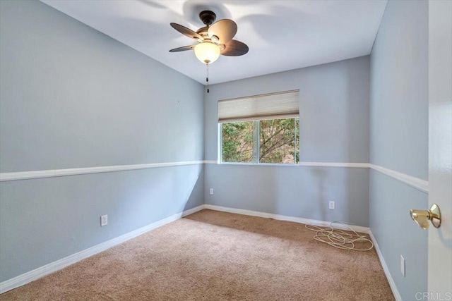 spare room featuring carpet floors and ceiling fan