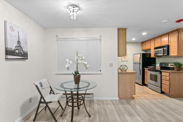 dining room with an inviting chandelier and light hardwood / wood-style flooring