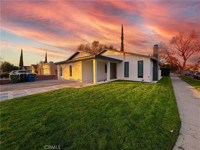 ranch-style house featuring a lawn