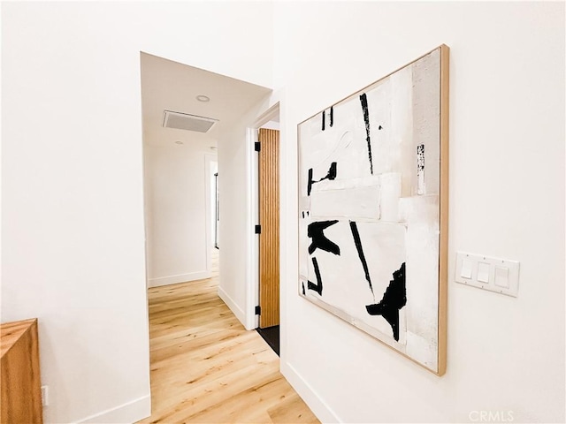 hallway with hardwood / wood-style floors