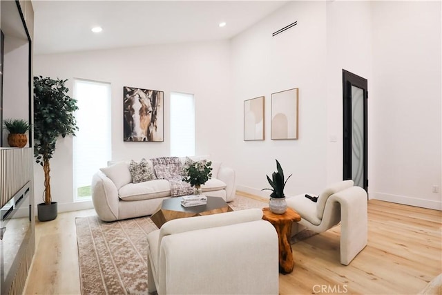 living room with lofted ceiling and hardwood / wood-style floors