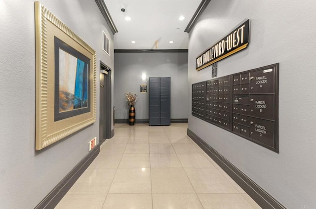 hallway featuring ornamental molding, tile patterned floors, mail area, baseboards, and elevator