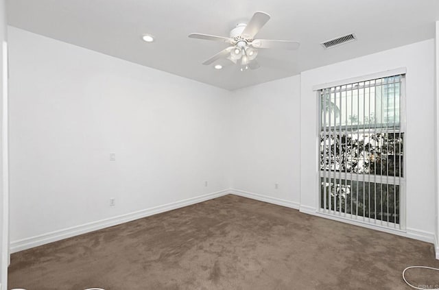 empty room featuring visible vents, recessed lighting, carpet floors, a ceiling fan, and baseboards
