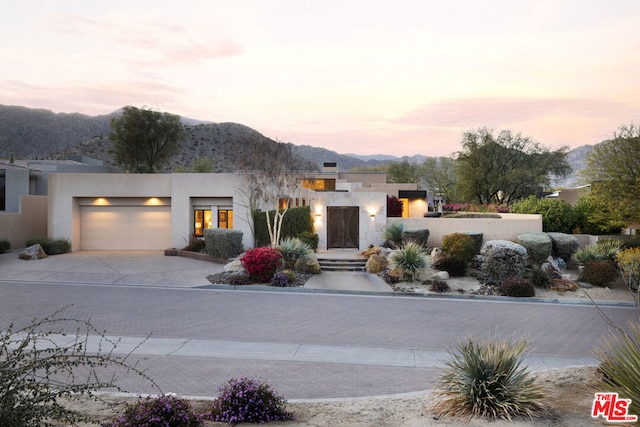 view of front of home featuring a garage and a mountain view