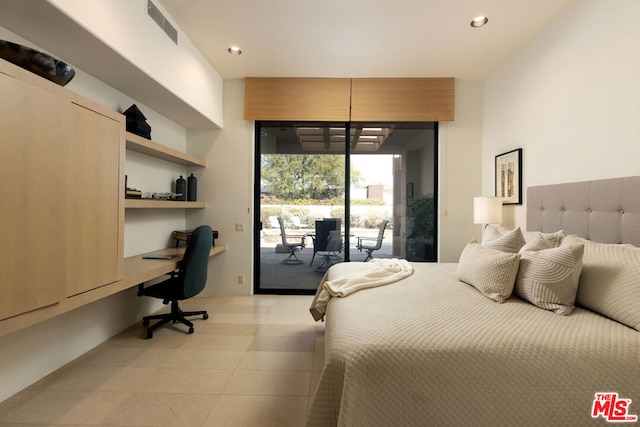 bedroom with light tile patterned floors, built in desk, and access to outside