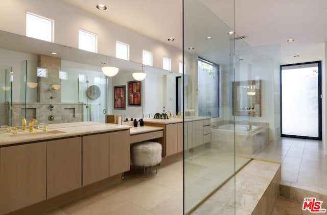 bathroom with tile patterned floors, vanity, and shower with separate bathtub