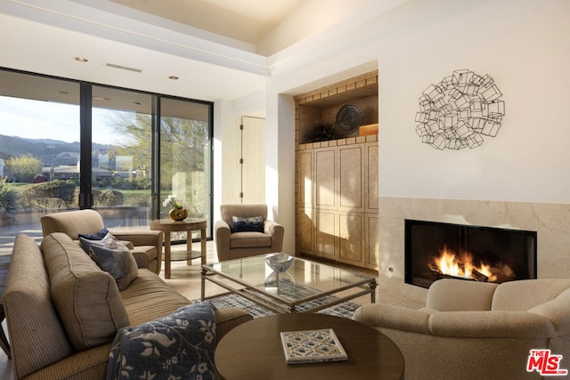 living room featuring floor to ceiling windows and a fireplace