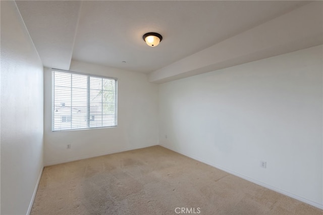 unfurnished room featuring light colored carpet