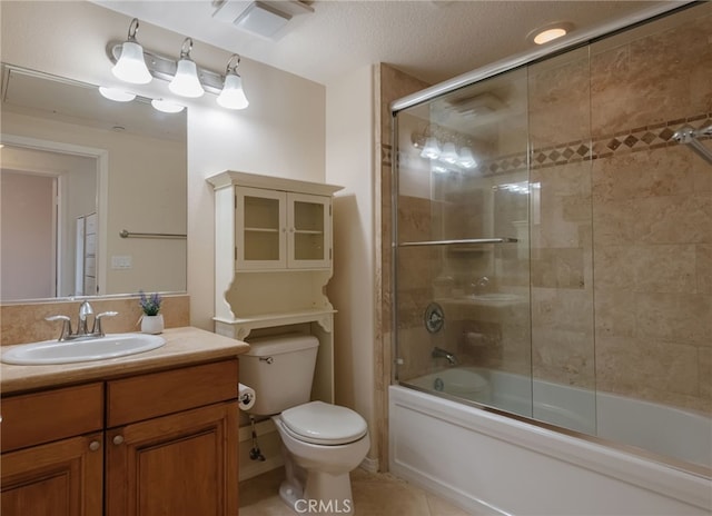 full bathroom featuring shower / bath combination with glass door, vanity, a textured ceiling, tile patterned floors, and toilet