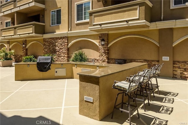 view of patio / terrace with an outdoor wet bar