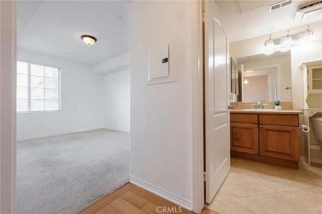 bathroom featuring vanity, electric panel, and toilet