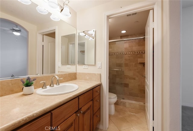 bathroom with an enclosed shower, ceiling fan, vanity, and toilet