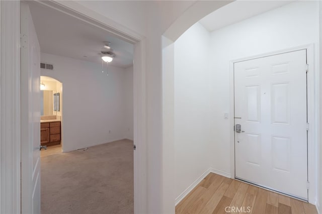 foyer entrance featuring ceiling fan and light hardwood / wood-style floors