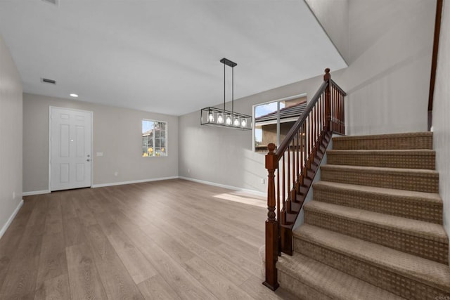 stairs with hardwood / wood-style flooring