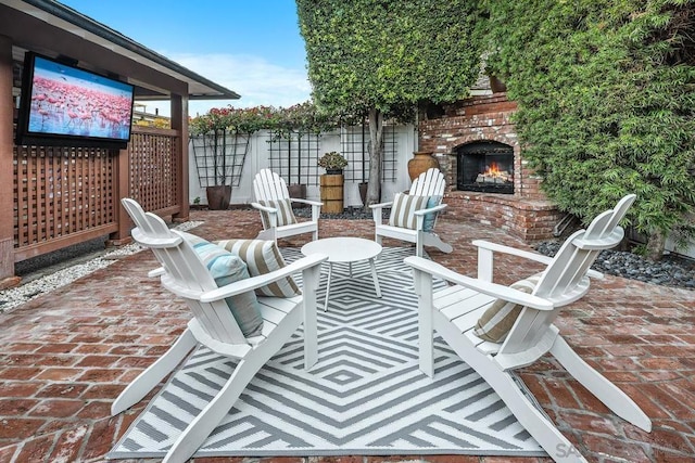 view of patio featuring an outdoor brick fireplace