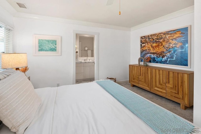 bedroom featuring crown molding, light colored carpet, ensuite bathroom, and sink