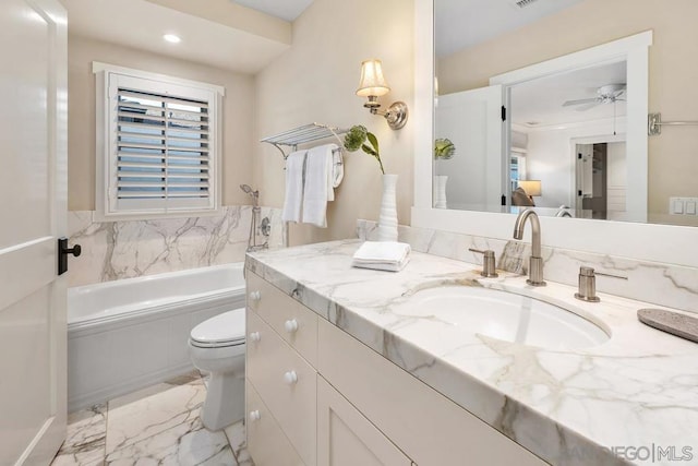 bathroom with a washtub, ceiling fan, vanity, and toilet