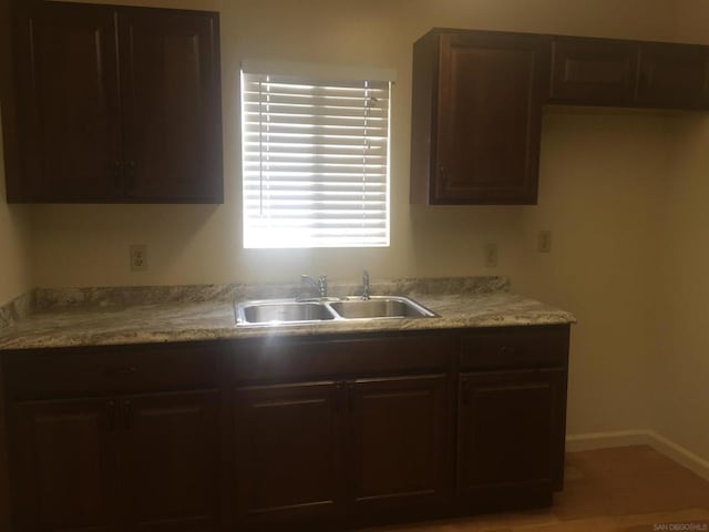 kitchen featuring sink and dark brown cabinets