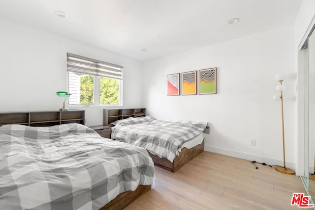 bedroom with light hardwood / wood-style floors